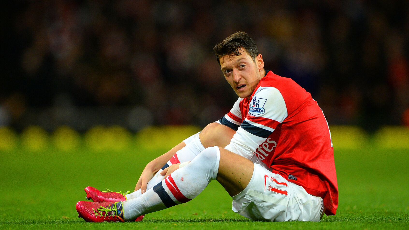 Mesut Ozil ties his boots.