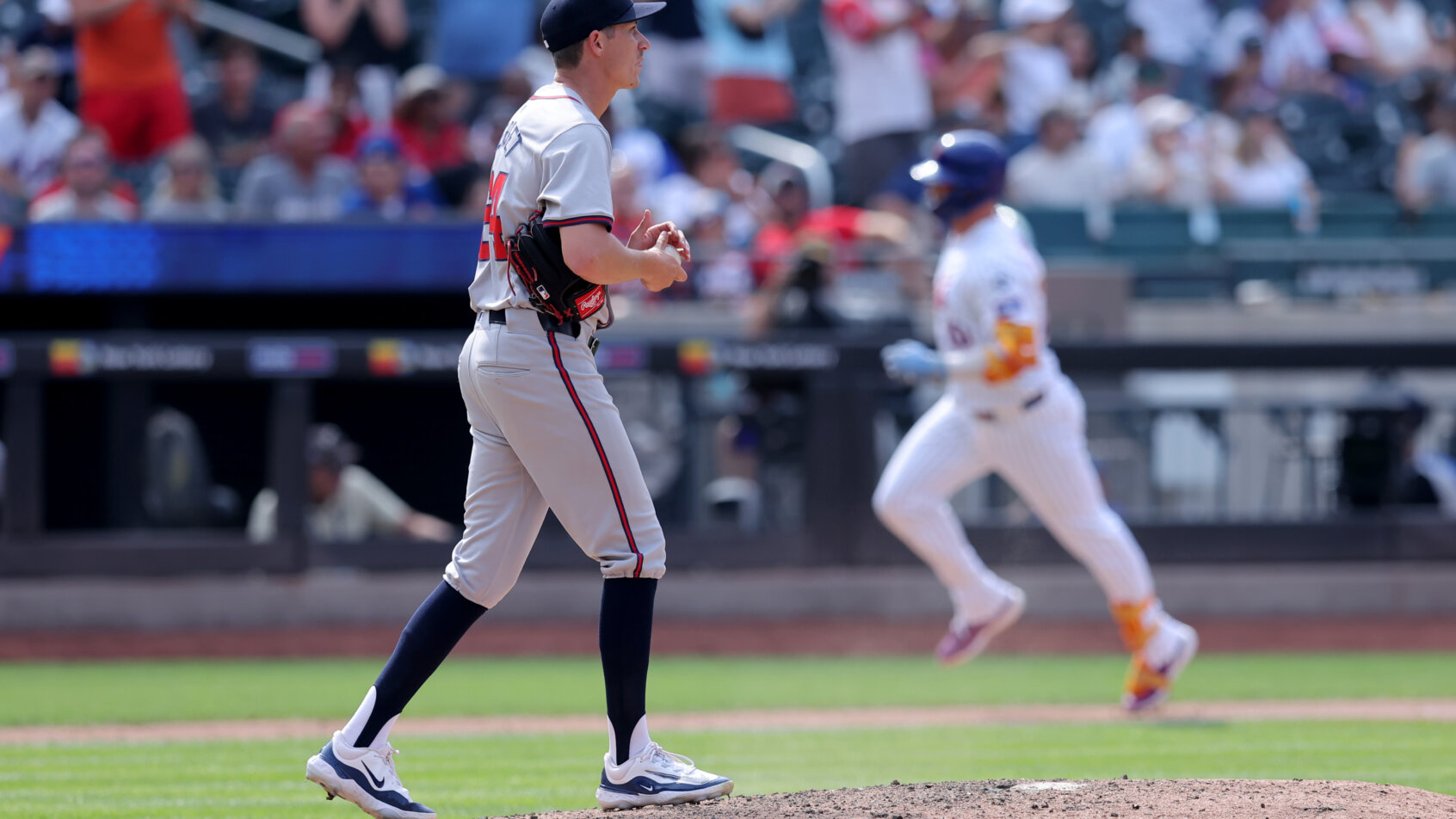 New York Mets first baseman Pete Alonso rounding the bases after hitting a home run against Atlanta Braves relief pitcher Jimmy Herget