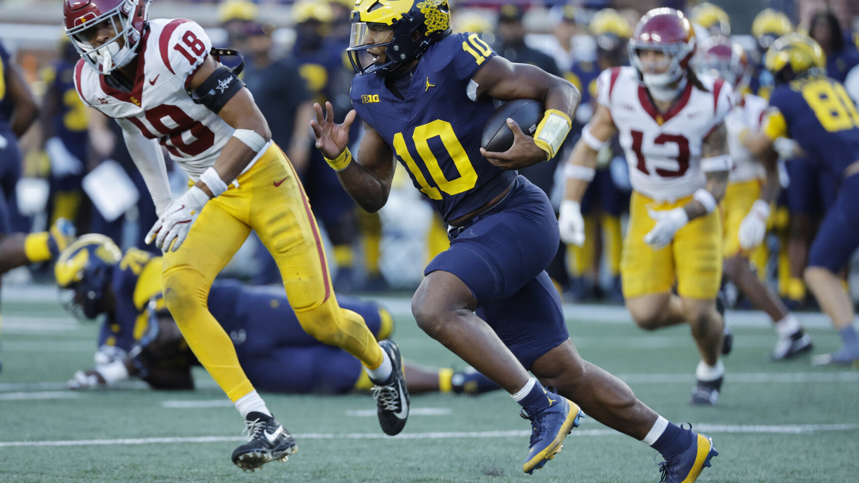 Michigan Wolverines quarterback Alex Orji runs in the second half