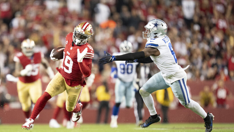 San Francisco 49ers wide receiver Deebo Samuel tries to escape a tackle by Dallas Cowboys safety Donovan Wilson