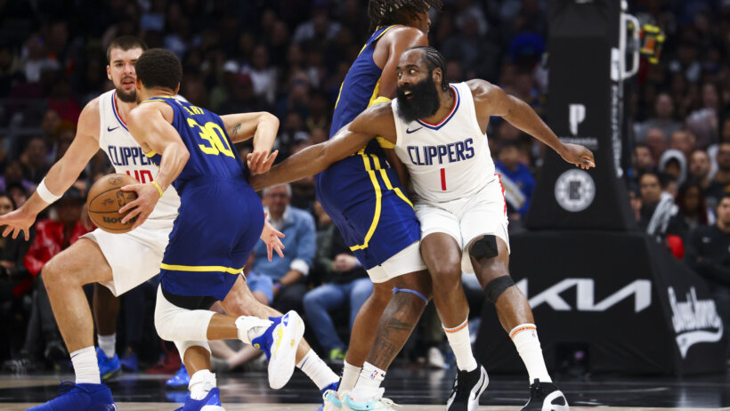 Golden State Warriors guard Stephen Curry tries to dribble past LA Clippers guard James Harden