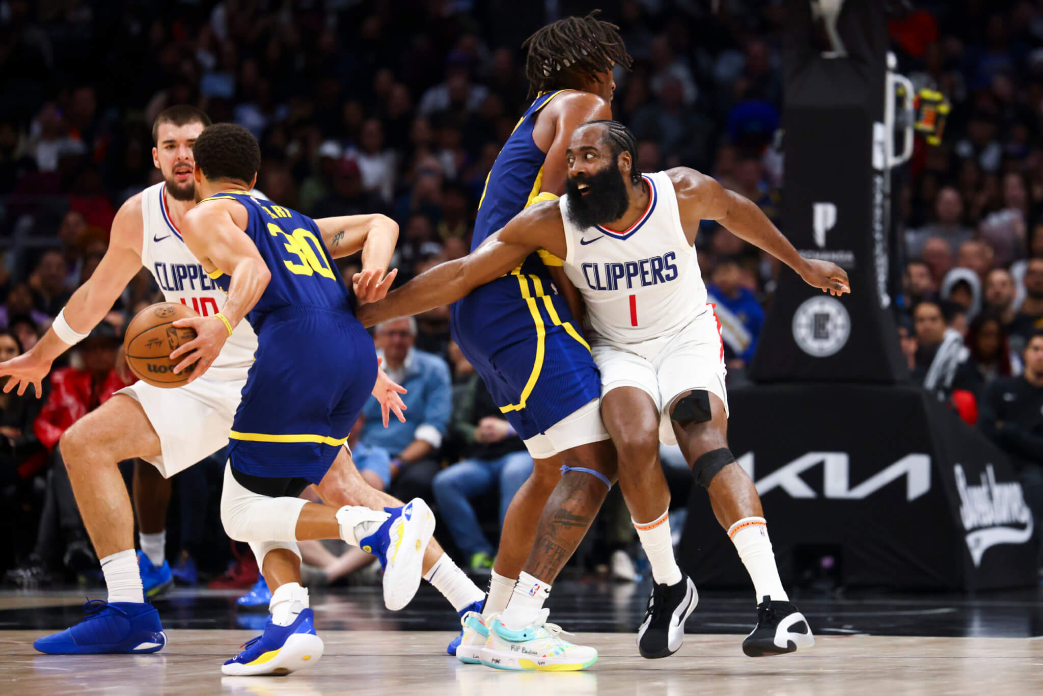 Golden State Warriors guard Stephen Curry tries to dribble past LA Clippers guard James Harden