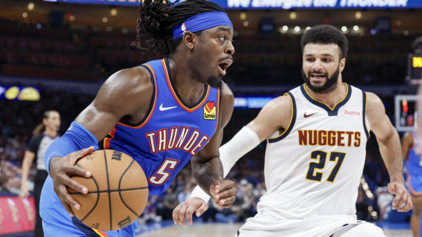 Oklahoma City Thunder guard Luguentz Dort drives around Denver Nuggets guard Jamal Murray