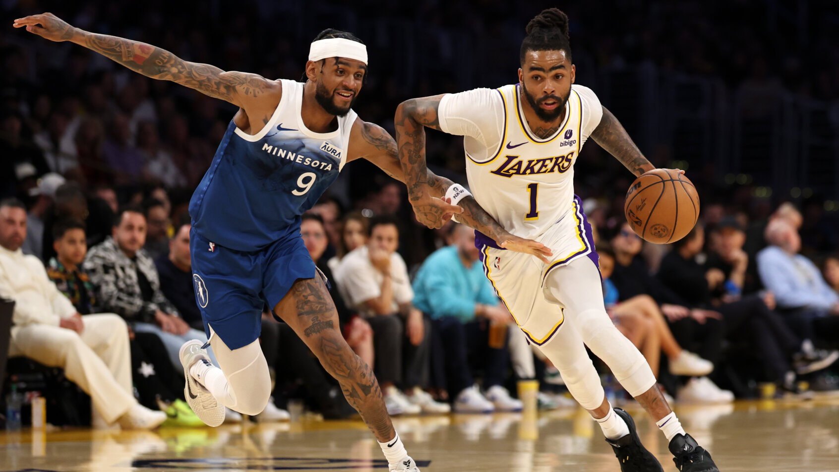 Los Angeles Lakers guard D'Angelo Russell dribbles around Minnesota Timberwolves guard Nickeil Alexander-Walker