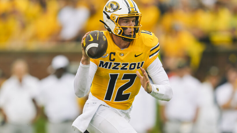 Missouri Tigers quarterback Brady Cook scrambles during the first half