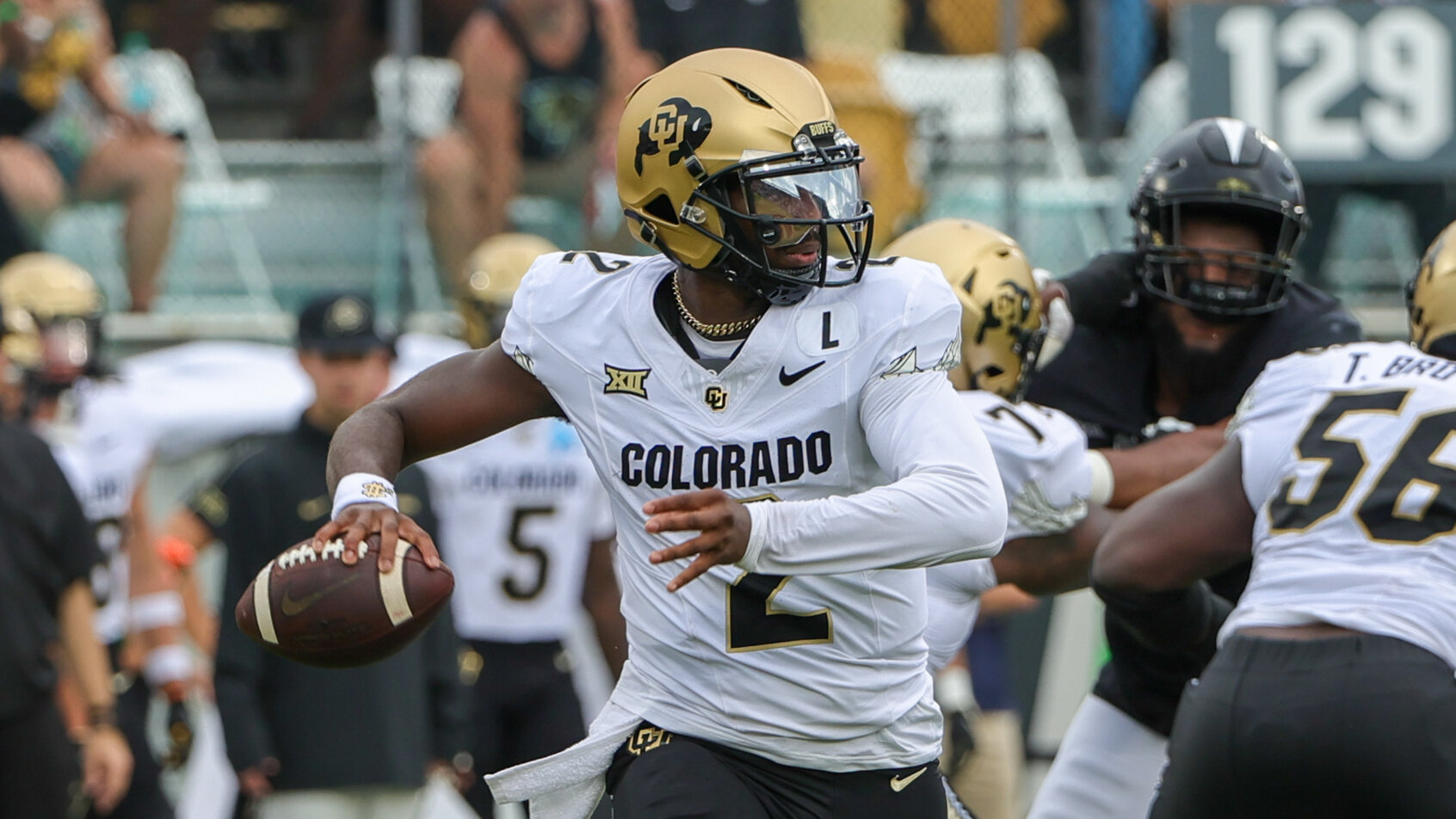 Colorado Buffaloes quarterback Shedeur Sanders rolls out to pass against the UCF Knights