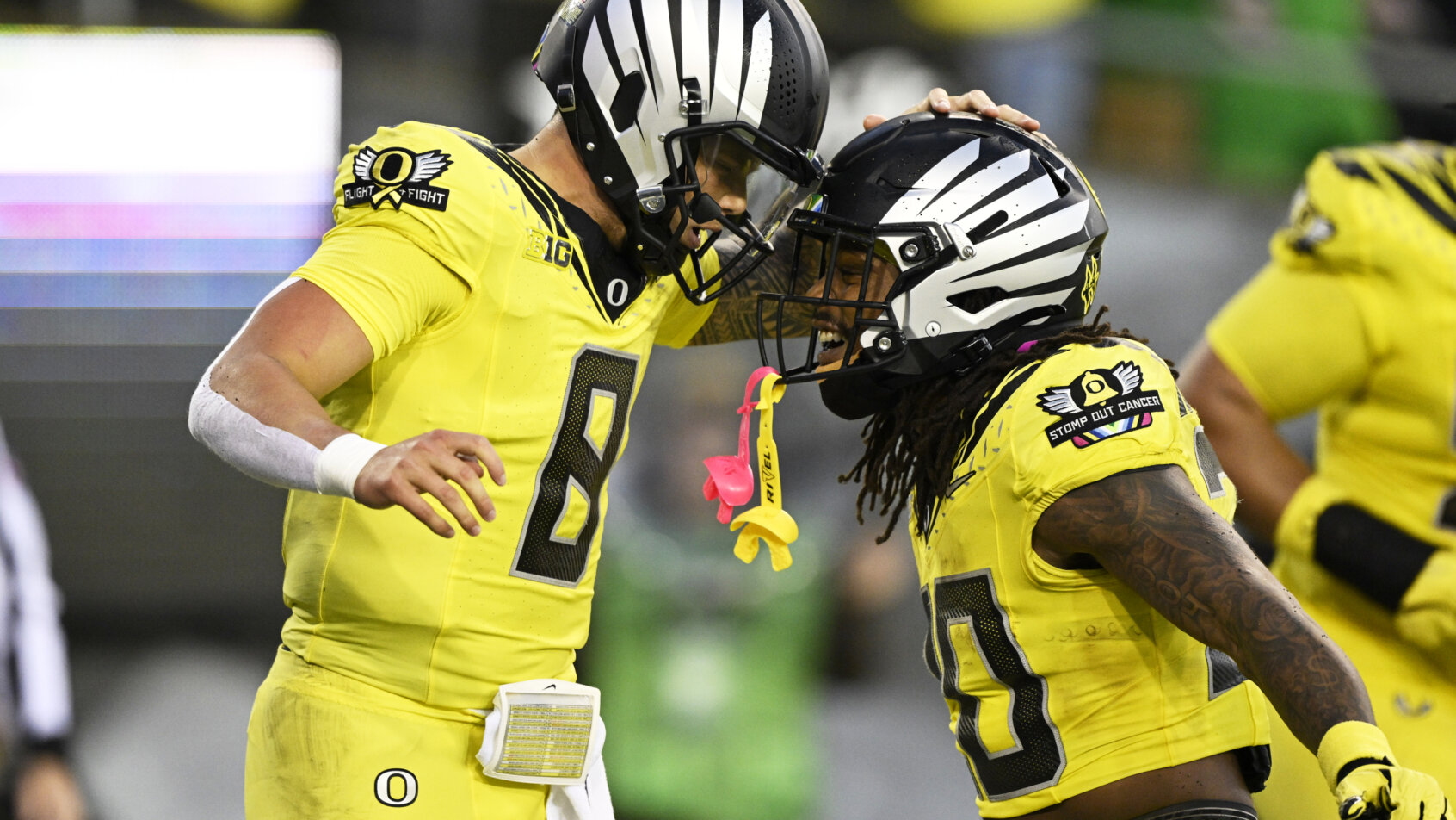 Oregon Ducks quarterback Dillon Gabriel celebrates after scoring a touchown with running back Jordan James