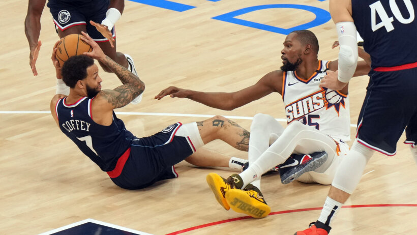 LA Clippers guard Amir Coffey grabs a loose ball ahead of Phoenix Suns forward Kevin Durant