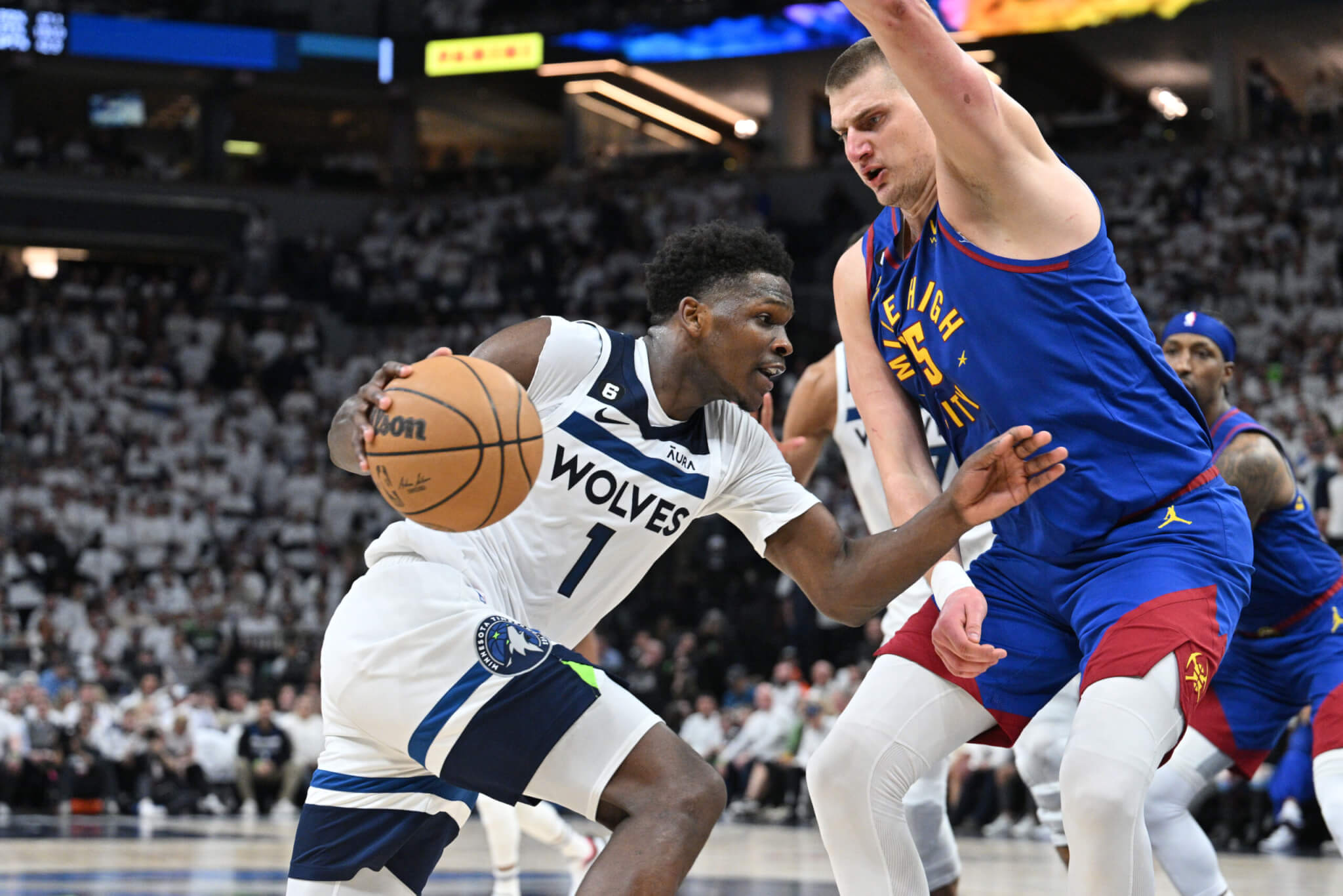Timberwolves guard Anthony Edwards goes to the basket against Denver Nuggets center Nikola Jokic