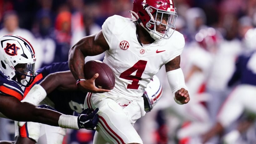 Alabama Crimson Tide quarterback Jalen Milroe scrambles out of the pocket against the Auburn Tigers