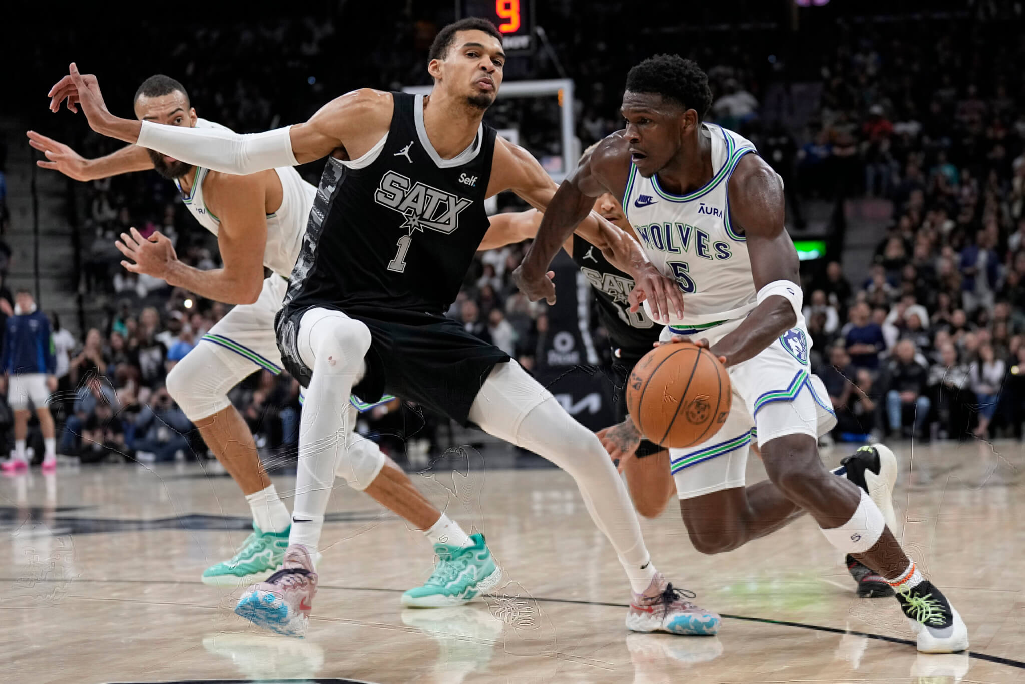 Timberwolves guard Anthony Edwards drives to the basket against San Antonio Spurs forward Victor Wembanyama