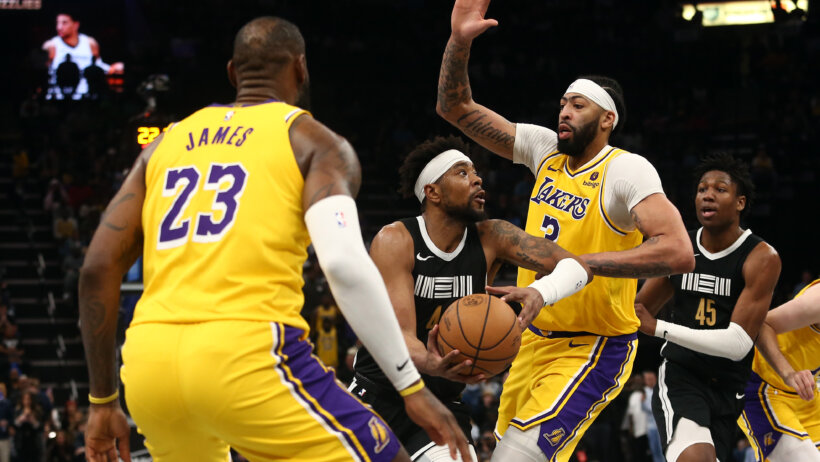 Memphis Grizzlies guard Jordan Goodwin defended by Los Angeles Lakers forward LeBron James and center Anthony Davis