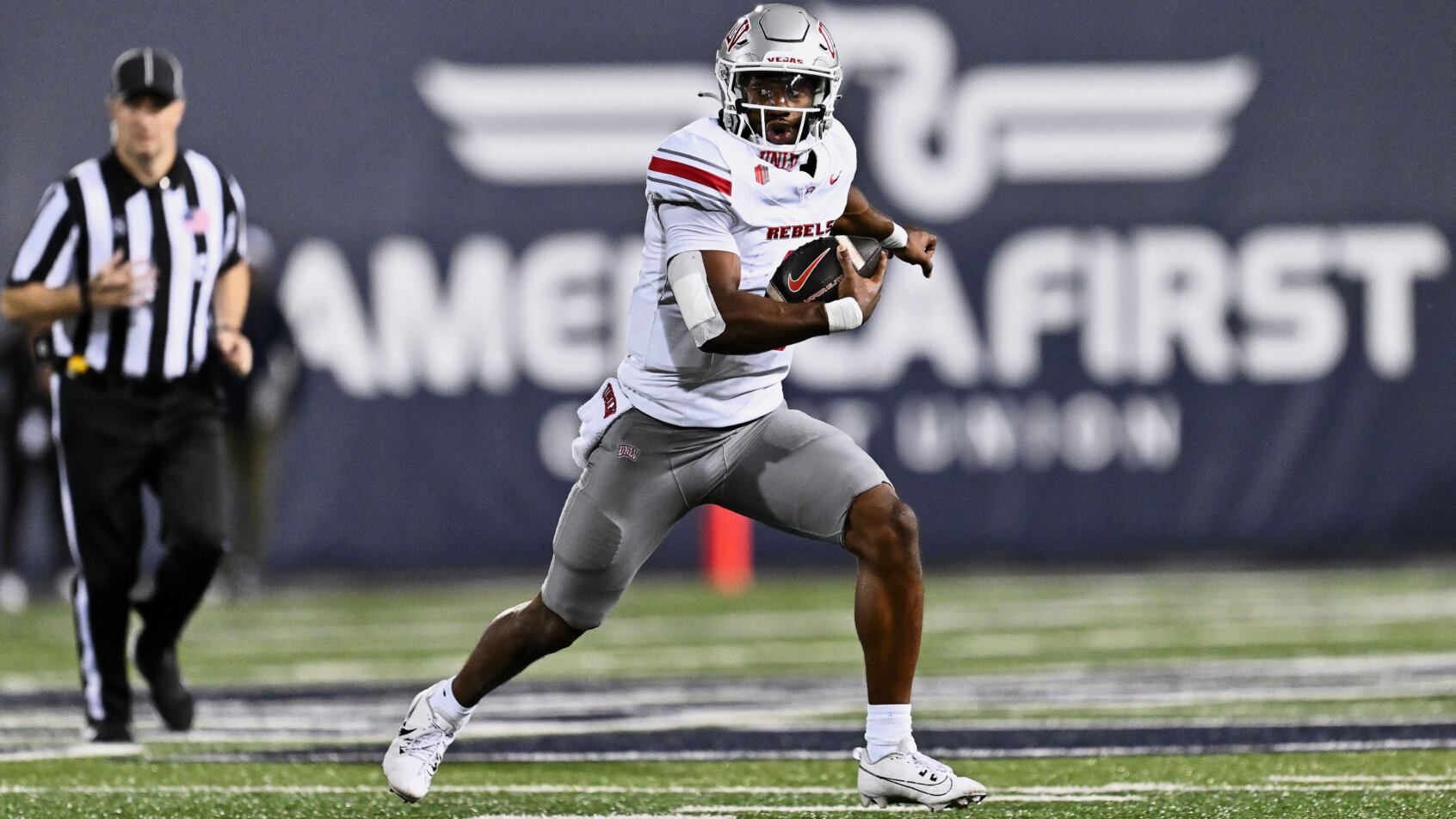 UNLV Rebels quarterback Hajj-Malik Williams runs with the bal