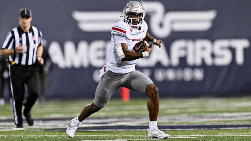 UNLV Rebels quarterback Hajj-Malik Williams runs with the bal