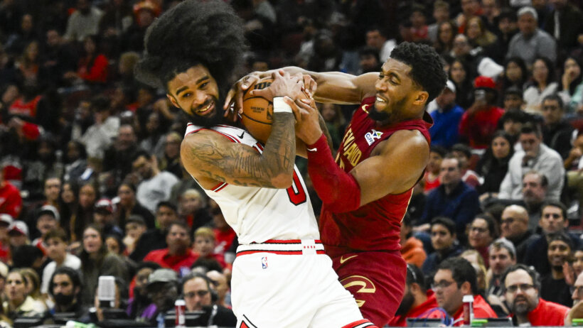 Chicago Bulls guard Coby White fights for the ball with Cleveland Cavaliers guard Donovan Mitchell