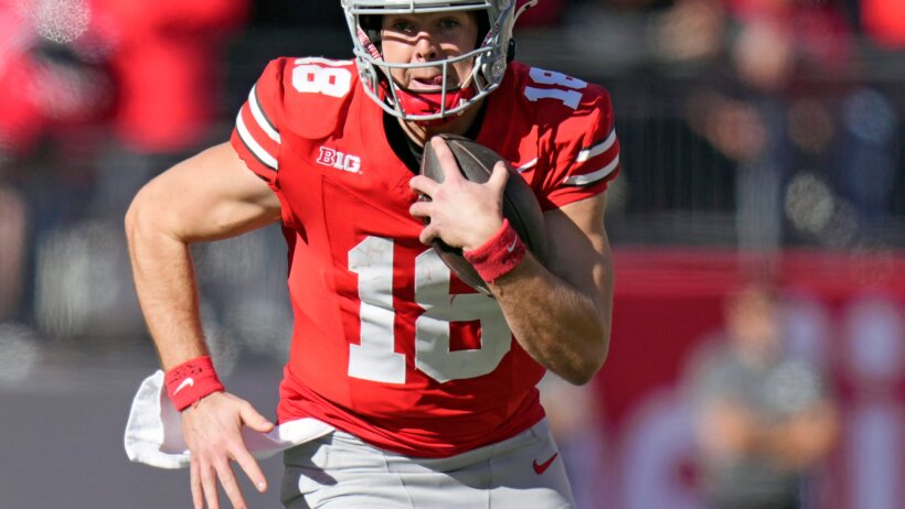 Ohio State Buckeyes quarterback Will Howard runs the ball