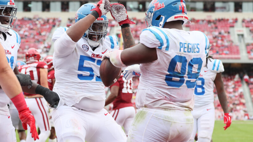 Ole Miss Rebels defensive tackle JJ Pegues celebrates with offensive lineman Micah Pettus