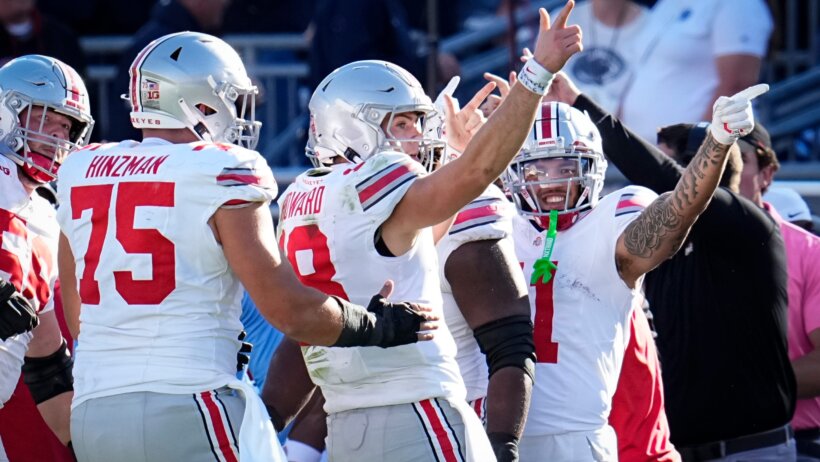 Ohio State Buckeyes quarterback Will Howard celebrates a first down run