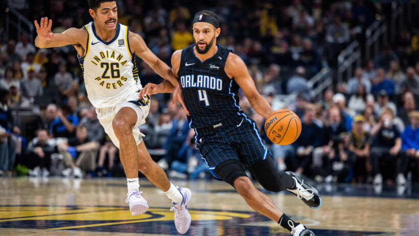 Orlando Magic guard Jalen Suggs dribbling around Indiana Pacers guard Ben Sheppard