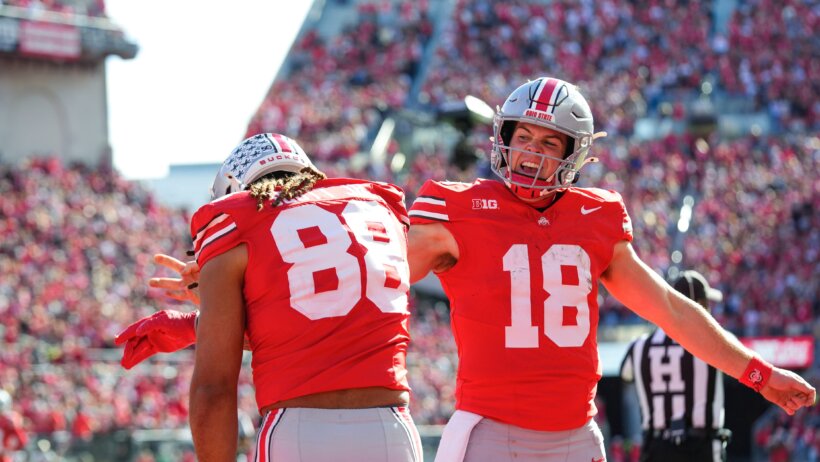 Ohio State Buckeyes quarterback Will Howard celebrates with tight end Gee Scott Jr.