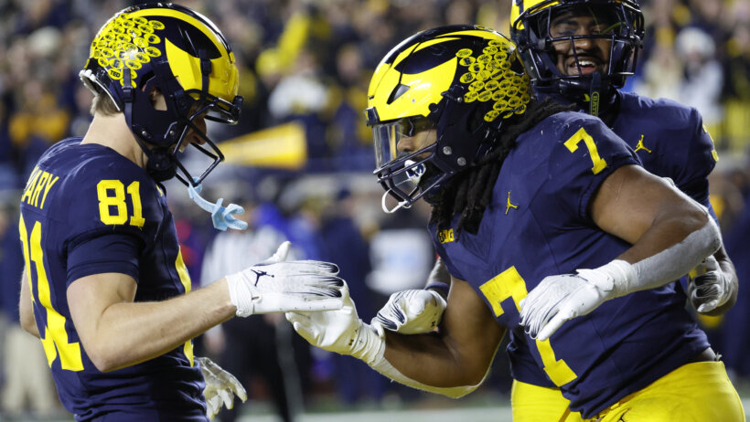 Michigan Wolverines running back Donovan Edwards celebrates with wide receiver Peyton O'Leary