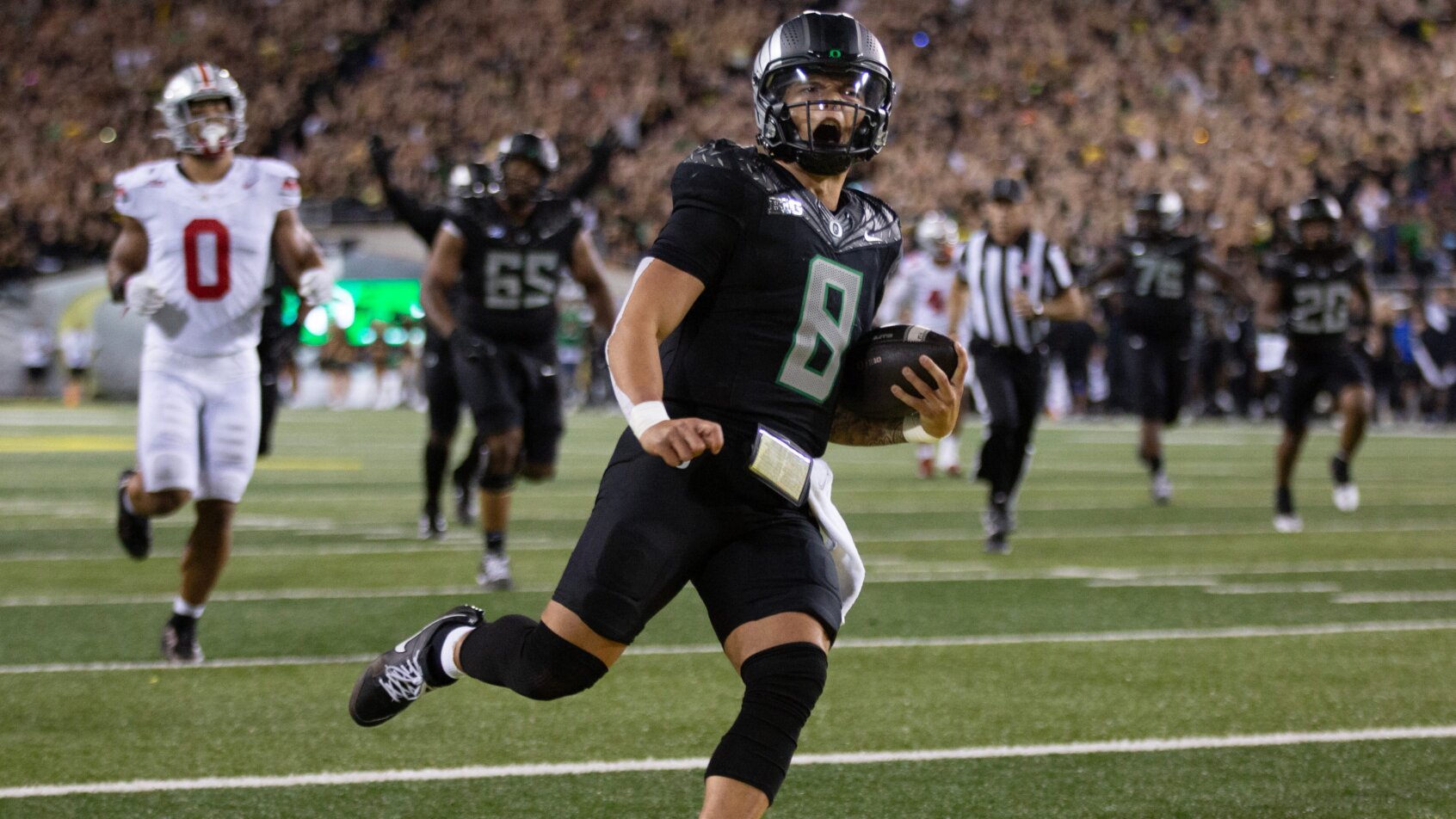 Oregon quarterback Dillon Gabriel scores a touchdown against Ohio State