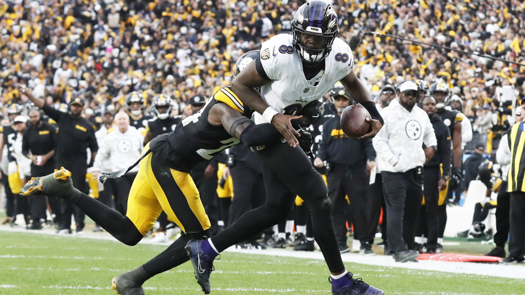 Lamar Jackson is chased down by a Steelers defender.