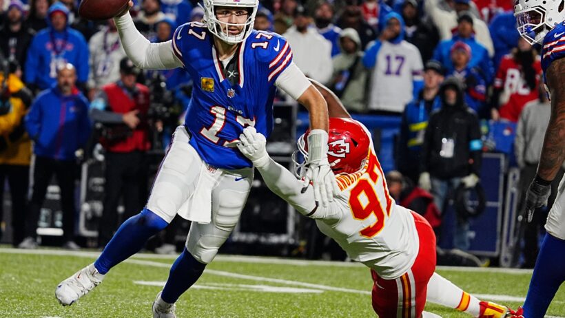 Buffalo Bills quarterback Josh Allen tries to throw a pass while getting tackled by Kansas City Chief Felix Anundike-Uzomah
