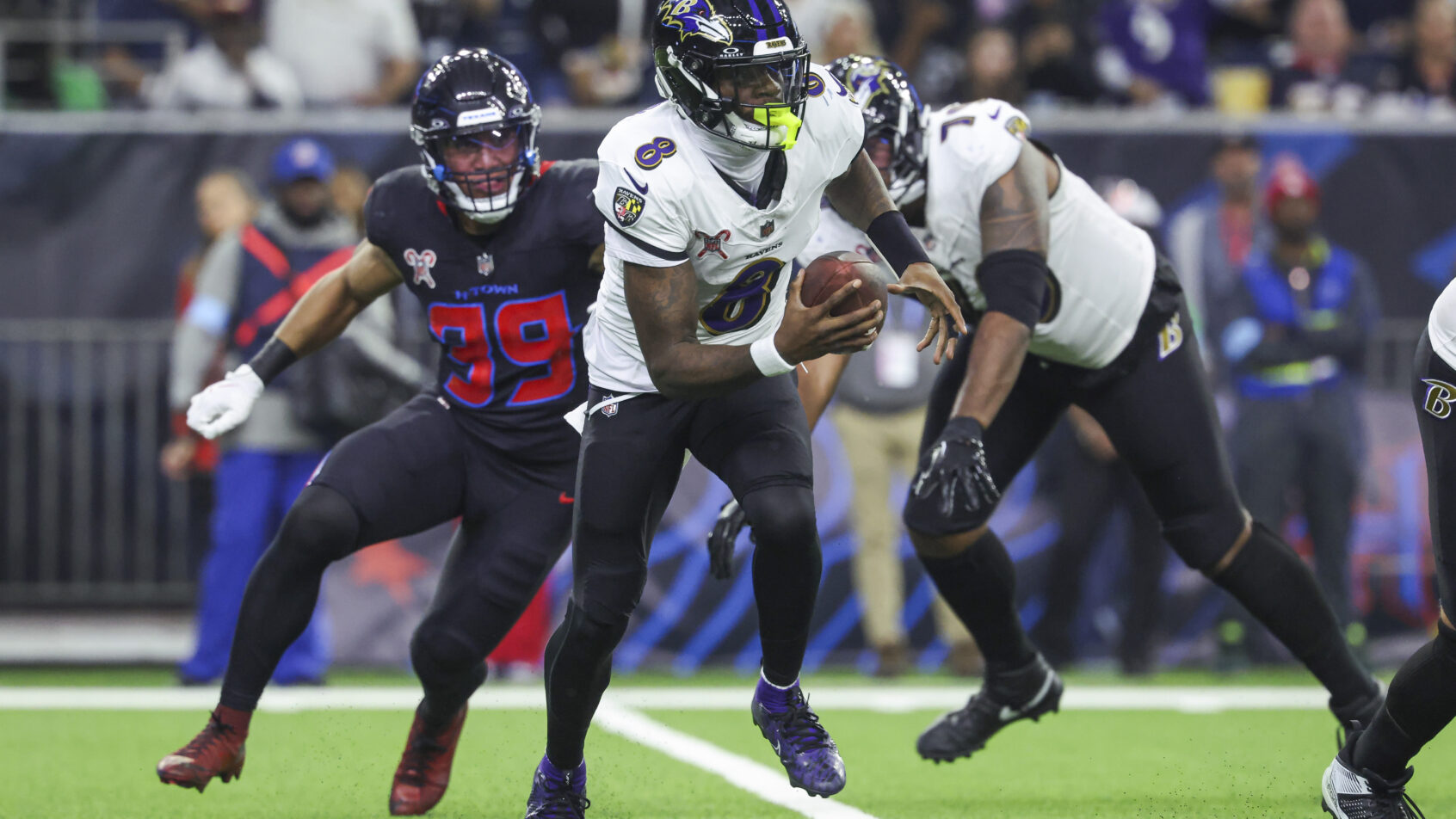Baltimore Ravens quarterback Lamar Jackson runs with the ball