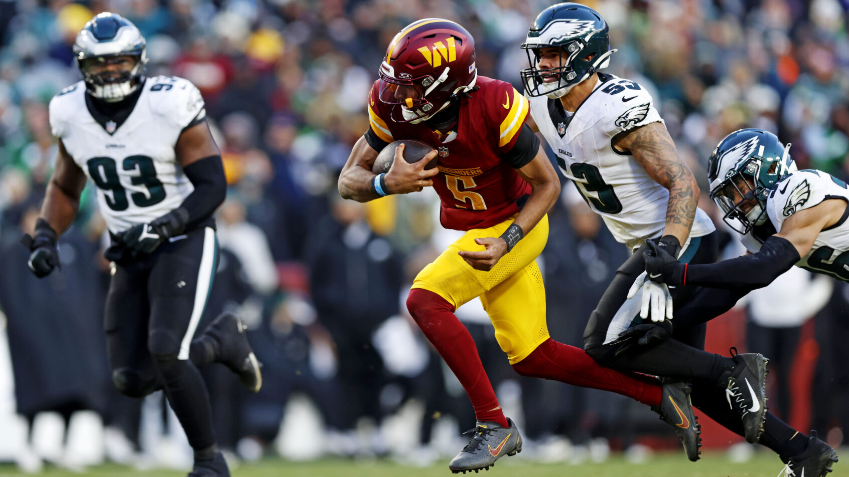 Washington Commanders quarterback Jayden Daniels runs with the ball against the Philadelphia Eagles