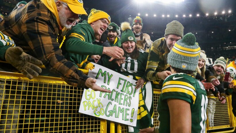 Green Bay Packers quarterback Jordan Love greeting fans at Lambeau Field