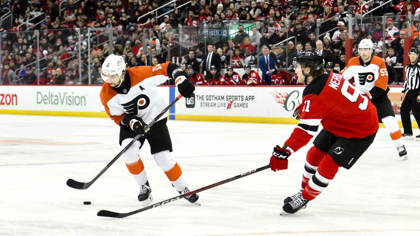 Travis Konecny and Dawson Mercer battle in the Devils zone.
