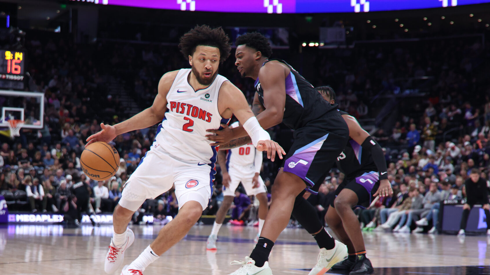 Detroit Pistons guard Cade Cunningham dribbles around Utah Jazz forward Brice Sensabaugh