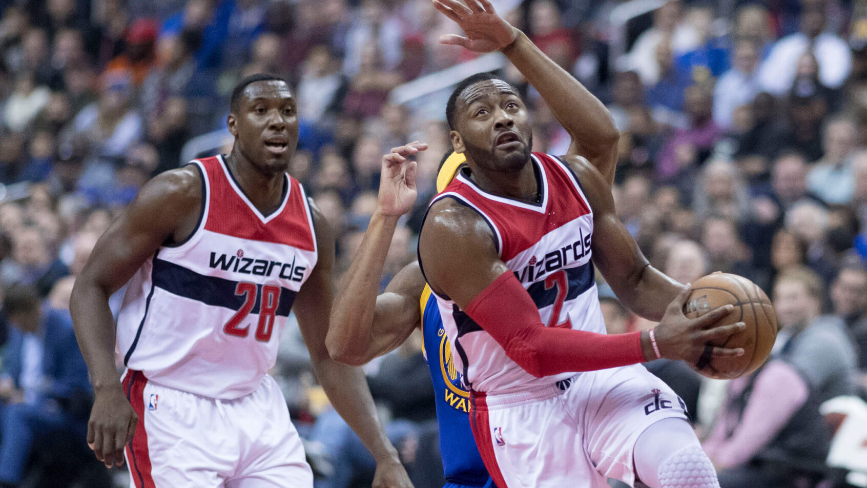 John Wall drives to the hoop against the Golden State Warriors.