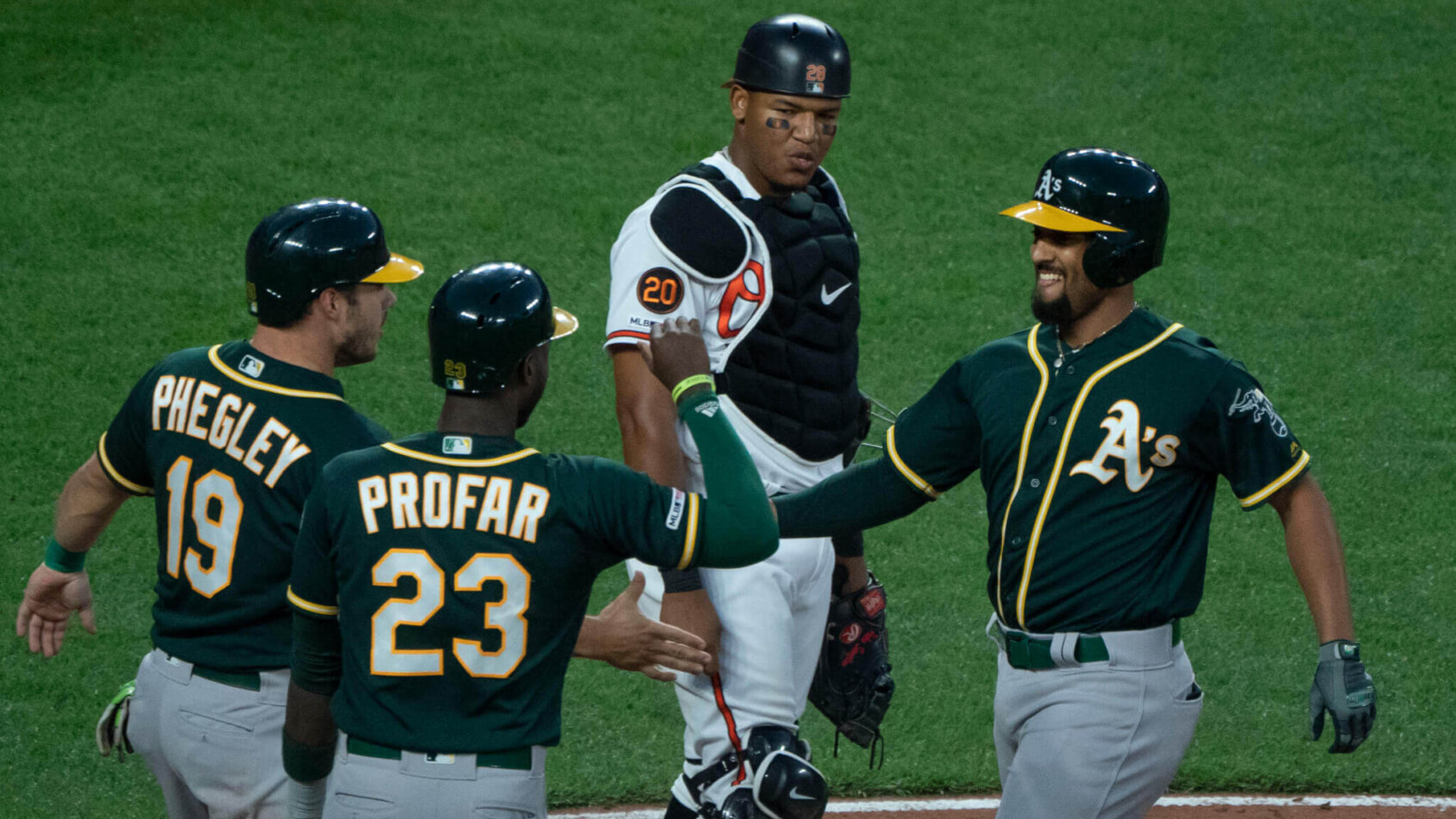 Oakland A's celebrate at home plate.