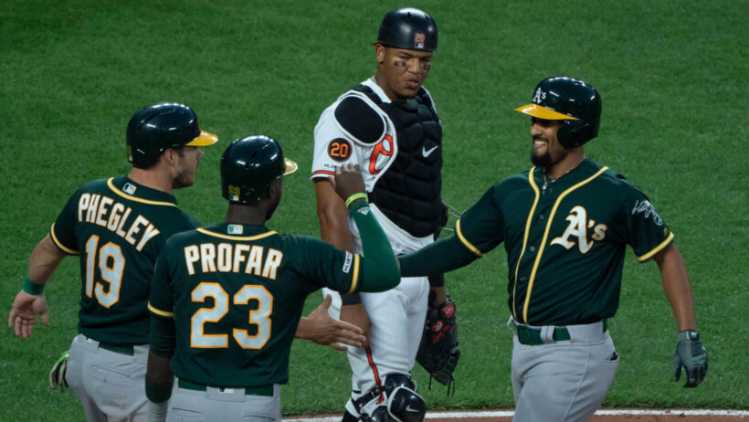 Oakland A's celebrate at home plate.