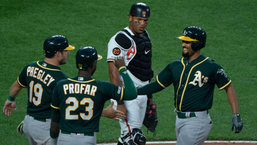 Members of the Oakland Athletics celebrate at home plate.