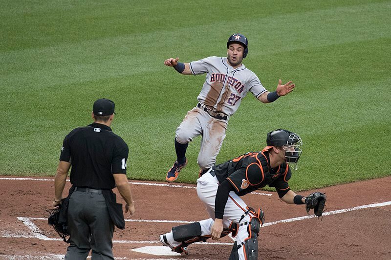 Jose ALtuve of the Houston Astros sliding into home