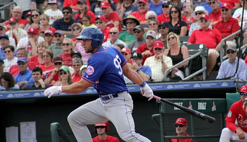 Tim Tebow connects with a pitch