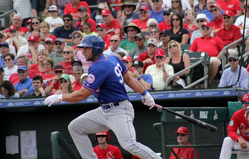 Tim Tebow connects with a pitch