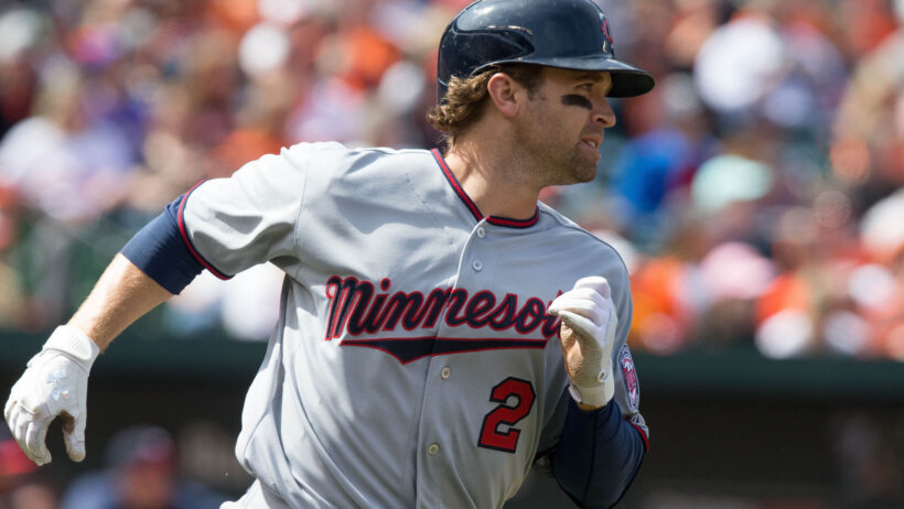 Brian Dozier runs to first base