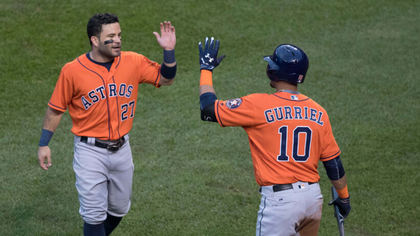 Jose Altuve high-fiving Gurriel