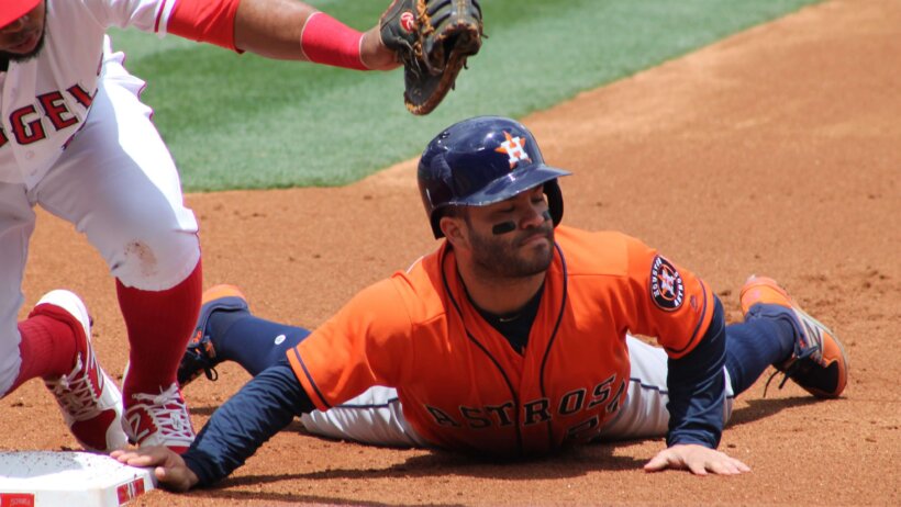 Jose Altuve sliding back into first base