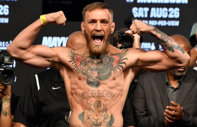 Conor McGregor flexing during a weigh in.