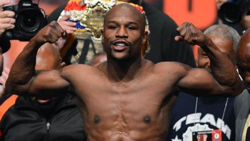 Floyd Mayweather flexing at a weigh-in