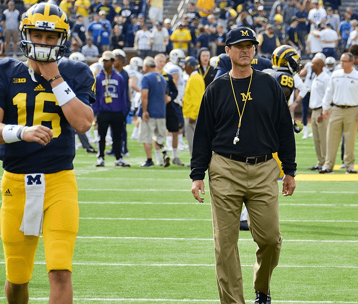 Jim Harbaugh walking across the field at the Big House