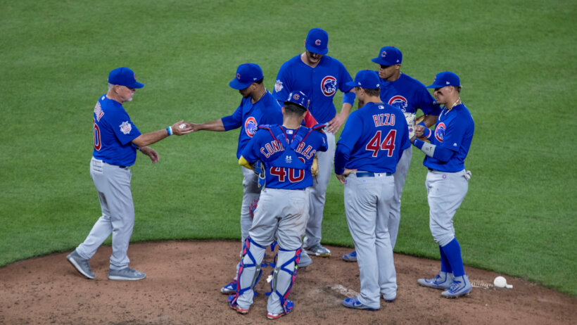 Members of the Chicago Cubs gather on the mound