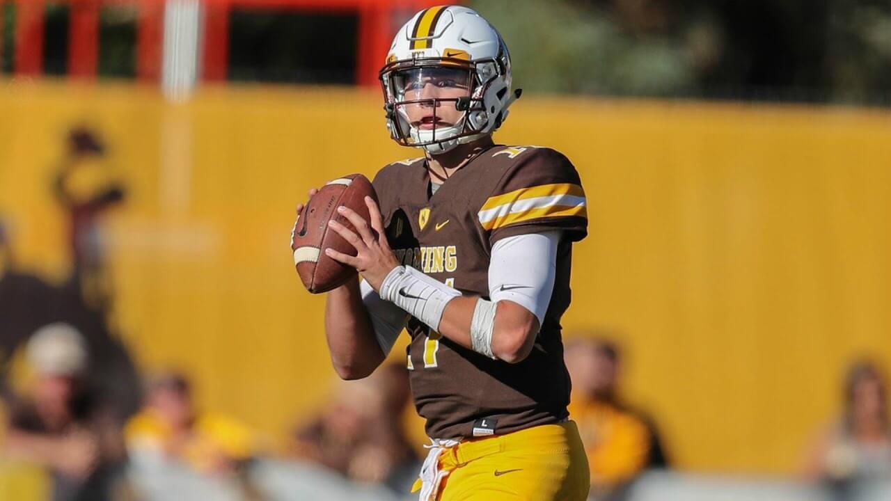 Josh Allen about to hit a Wyoming receiver on the numbers for an incomplete pass.