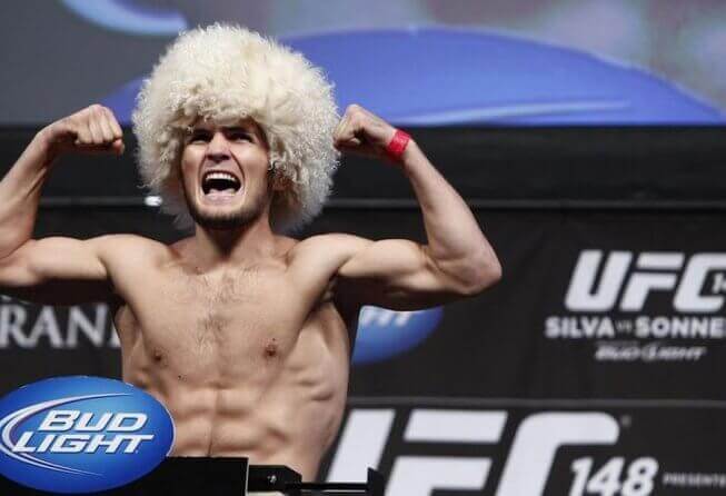 Khabib Nurmagomedov flexing at the UFC 148 weigh-ins.