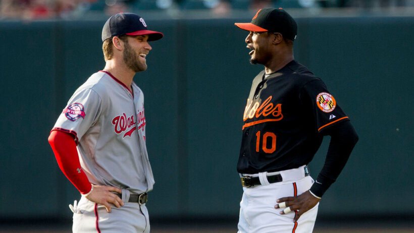 The Nationals' Bryce Harper talking with the Orioles' Adam Jones before a game.